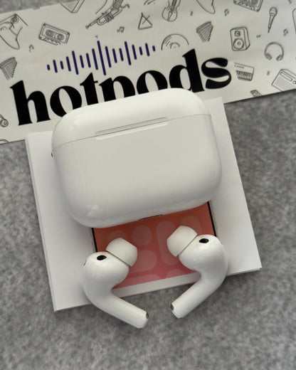 White wireless earbuds in a charging case on a gray surface with 'hotmods' branding in the background.